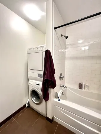 a bathroom with a tub and a shower