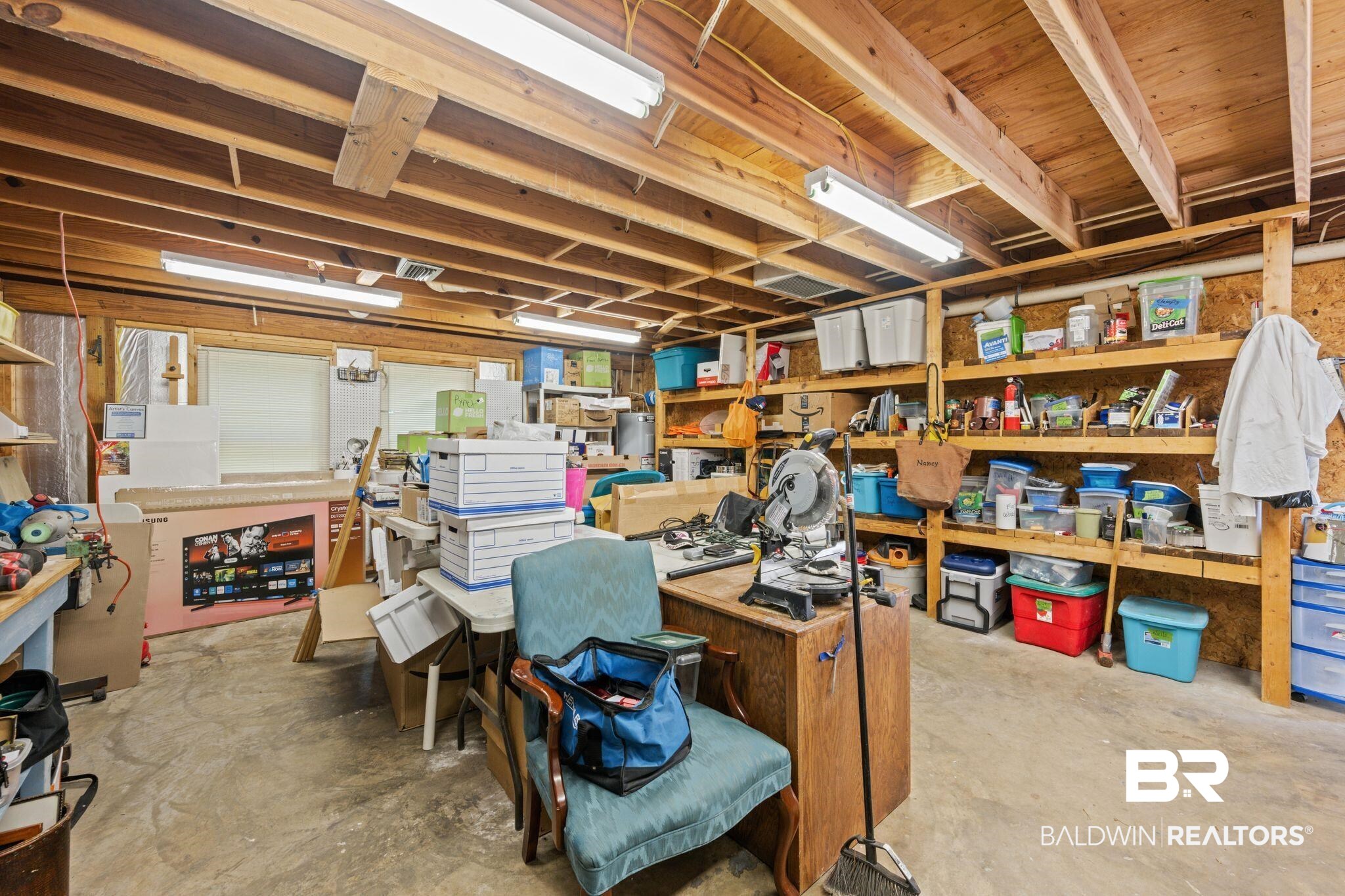 40 Caisson Trace Daphne, AL 36527 - Photo 34 of 54 Basement featuring a workshop area with storage.