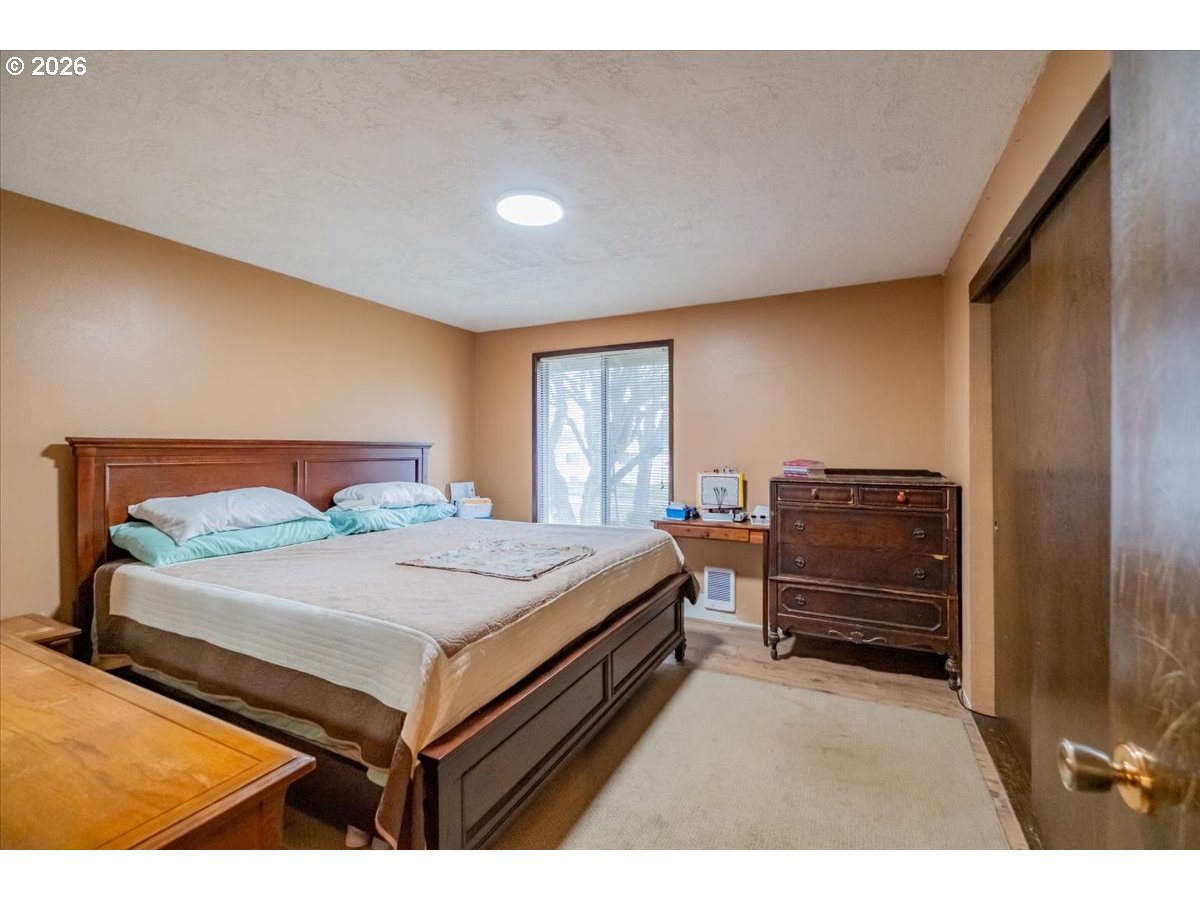 1360 Sunset Lane Sweet Home, OR 97386 - Photo 11 of 26 a bedroom with a bed and a dresser