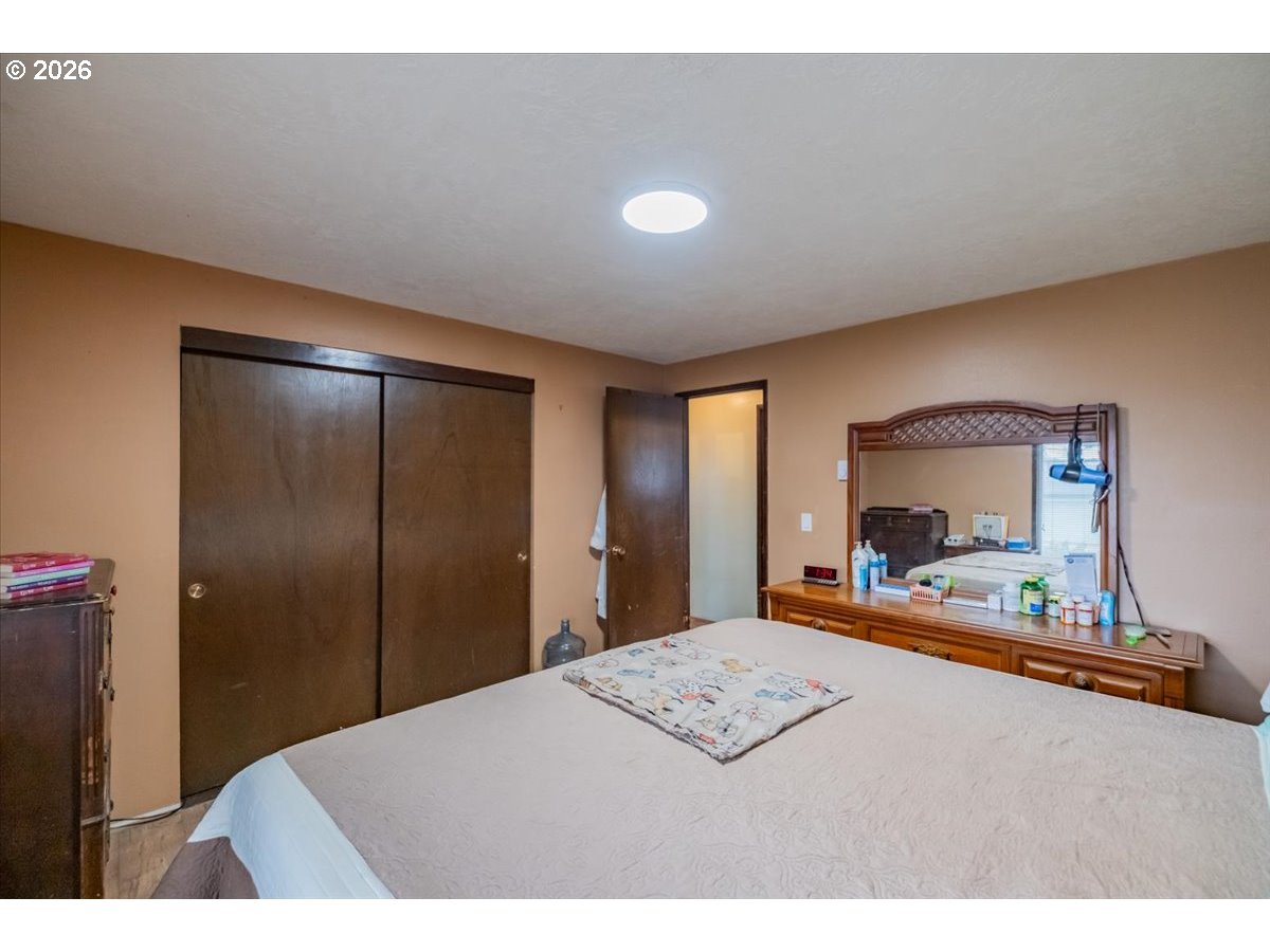 1360 Sunset Lane Sweet Home, OR 97386 - Photo 12 of 26 a bedroom with a bed and a dresser