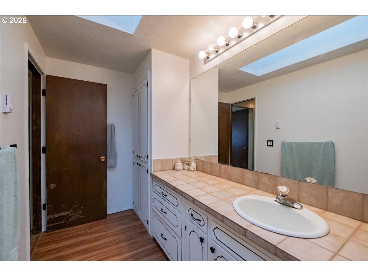 1360 Sunset Lane Sweet Home, OR 97386 - Photo 14 of 26 a bathroom with a granite countertop sink mirror and double