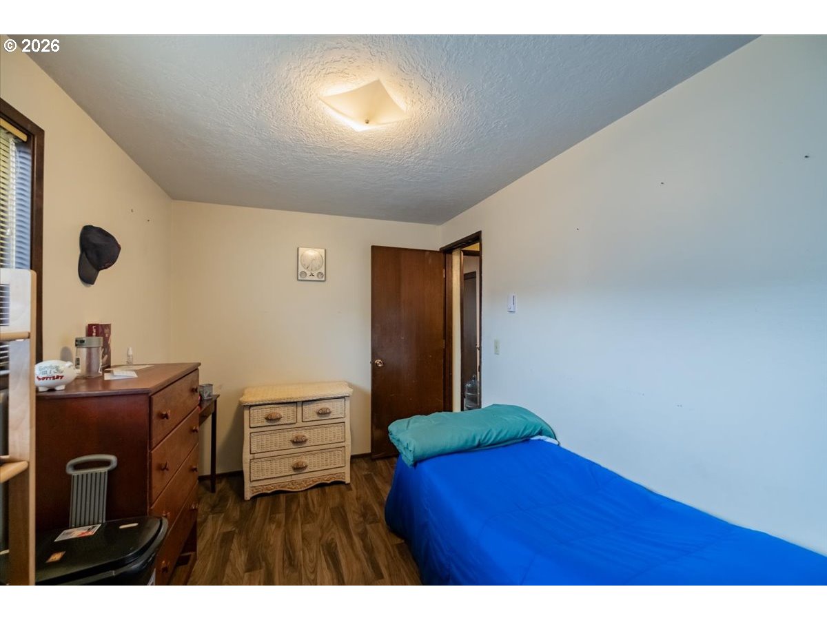 1360 Sunset Lane Sweet Home, OR 97386 - Photo 17 of 26 a bedroom with a bed and a desk