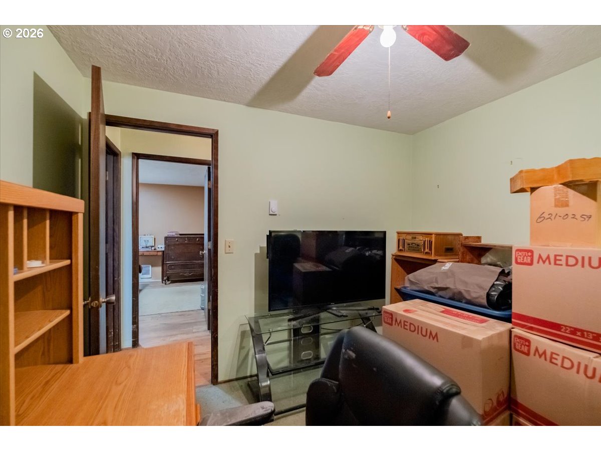 1360 Sunset Lane Sweet Home, OR 97386 - Photo 18 of 26 a living room with furniture and a flat screen tv
