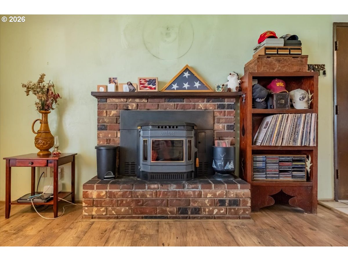 1360 Sunset Lane Sweet Home, OR 97386 - Photo 6 of 26 a living room with furniture a fireplace and a flat screen tv