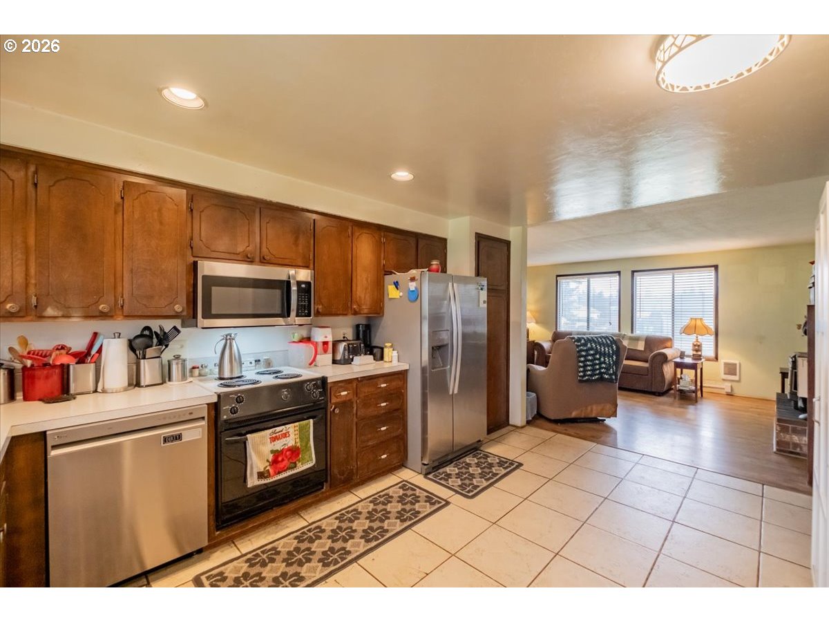 1360 Sunset Lane Sweet Home, OR 97386 - Photo 9 of 26 a kitchen with refrigerator and cabinets