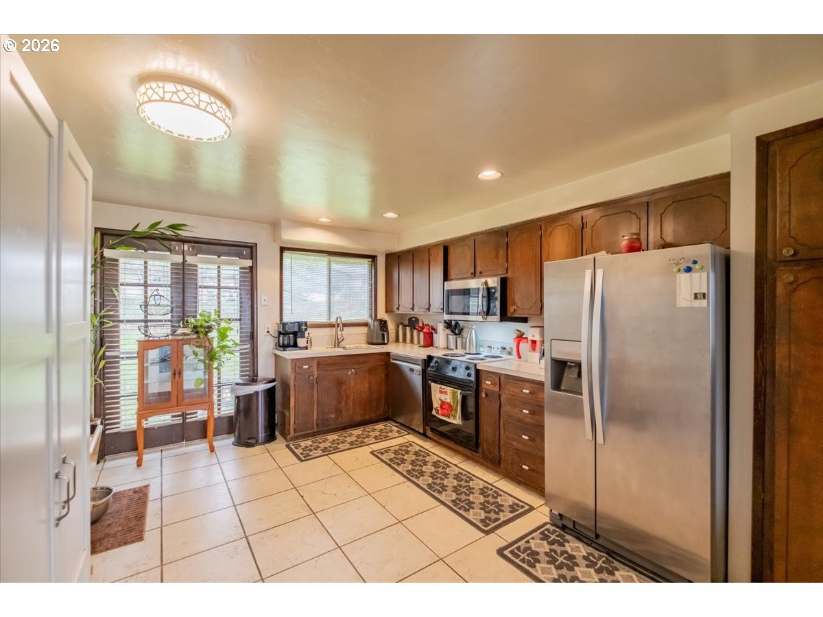 1360 Sunset Lane Sweet Home, OR 97386 - Photo 10 of 26 a kitchen with refrigerator and cabinets