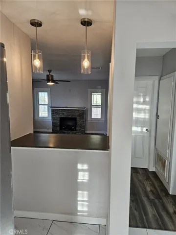 a living room with stainless steel appliances granite countertop furniture and a fireplace