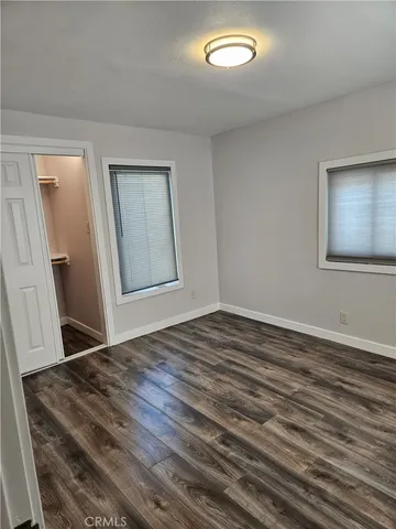 a view of a room with wooden floor and cabinet