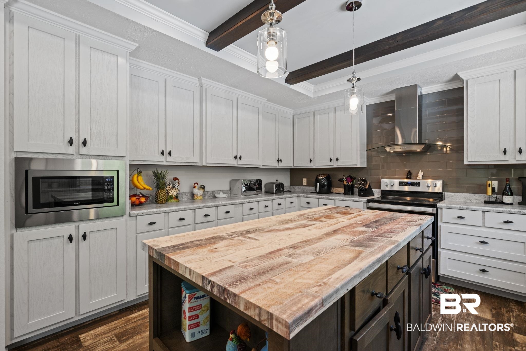 10703 South Ridge Drive Semmes, AL 36575 - Photo 14 of 37 Kitchen with wall chimney exhaust hood, appliances with stainless steel finishes, wood counters, beamed ceiling, and dark wood-style floors