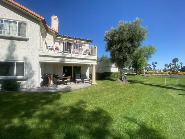 a view of a house with backyard sitting area and garden