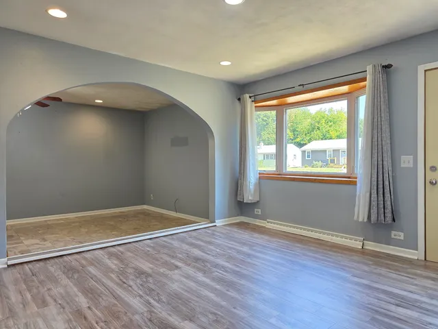 a view of room with window and wooden floor