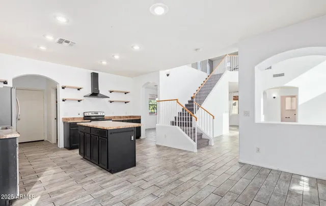 a kitchen with stainless steel appliances granite countertop a stove and a sink