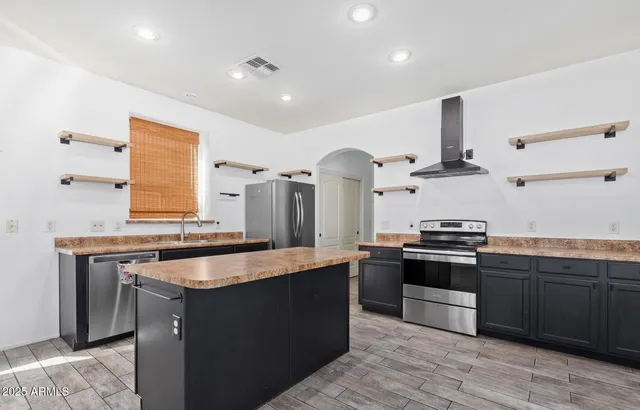 a kitchen with stainless steel appliances granite countertop a stove and a sink