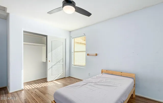 a bedroom with a bed and a window