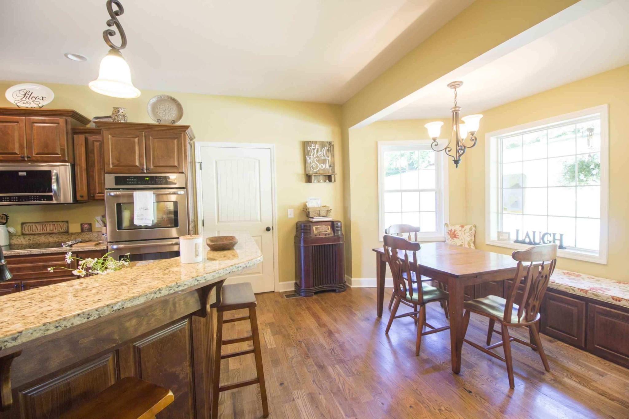 57 Lakeside Drive Carthage, TN 37030 - Photo 17 of 34 a kitchen with granite countertop a stove a refrigerator a dining table and chairs with wooden floor