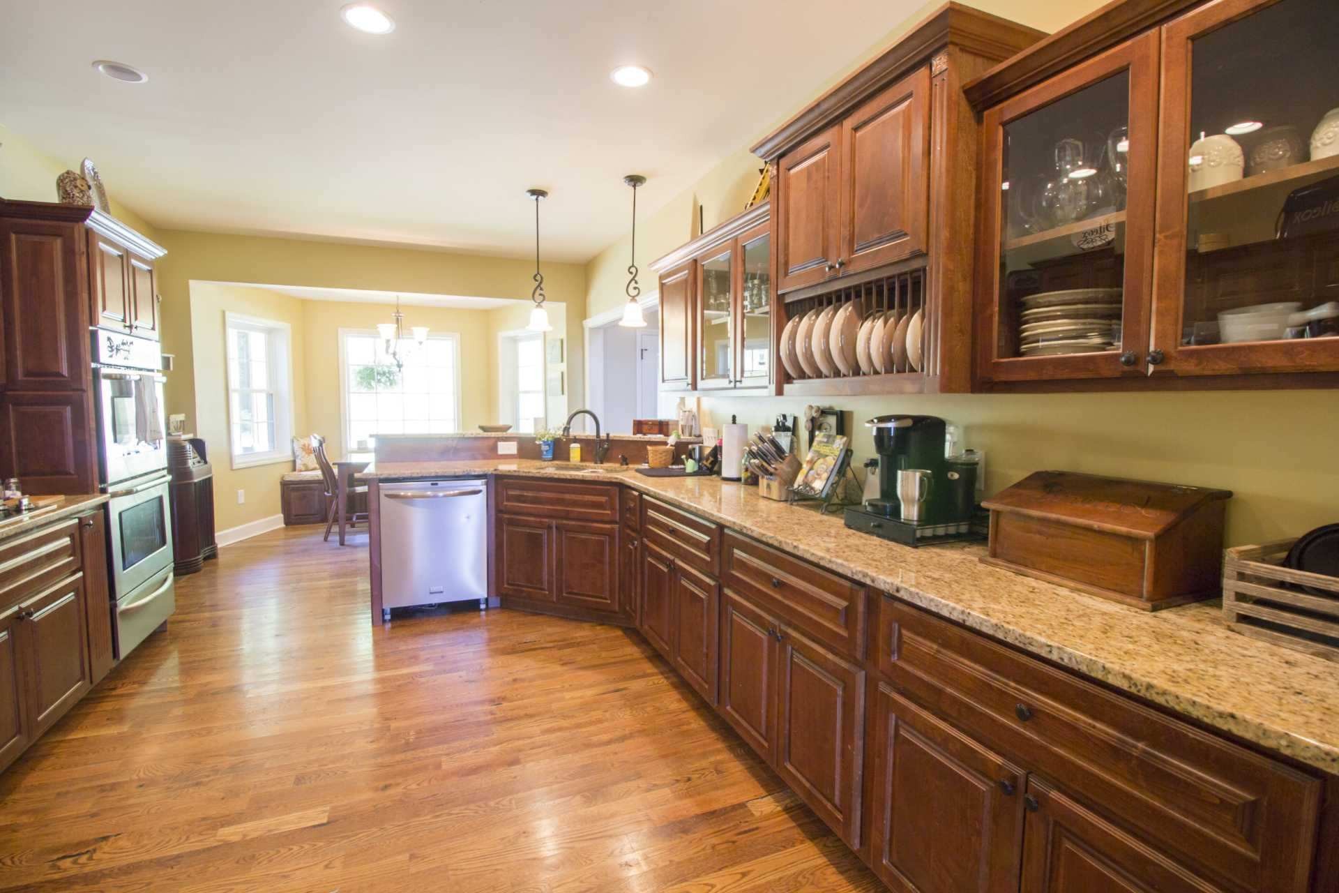 57 Lakeside Drive Carthage, TN 37030 - Photo 19 of 34 a kitchen with stainless steel appliances granite countertop wooden cabinets a sink a stove a dining table and chairs