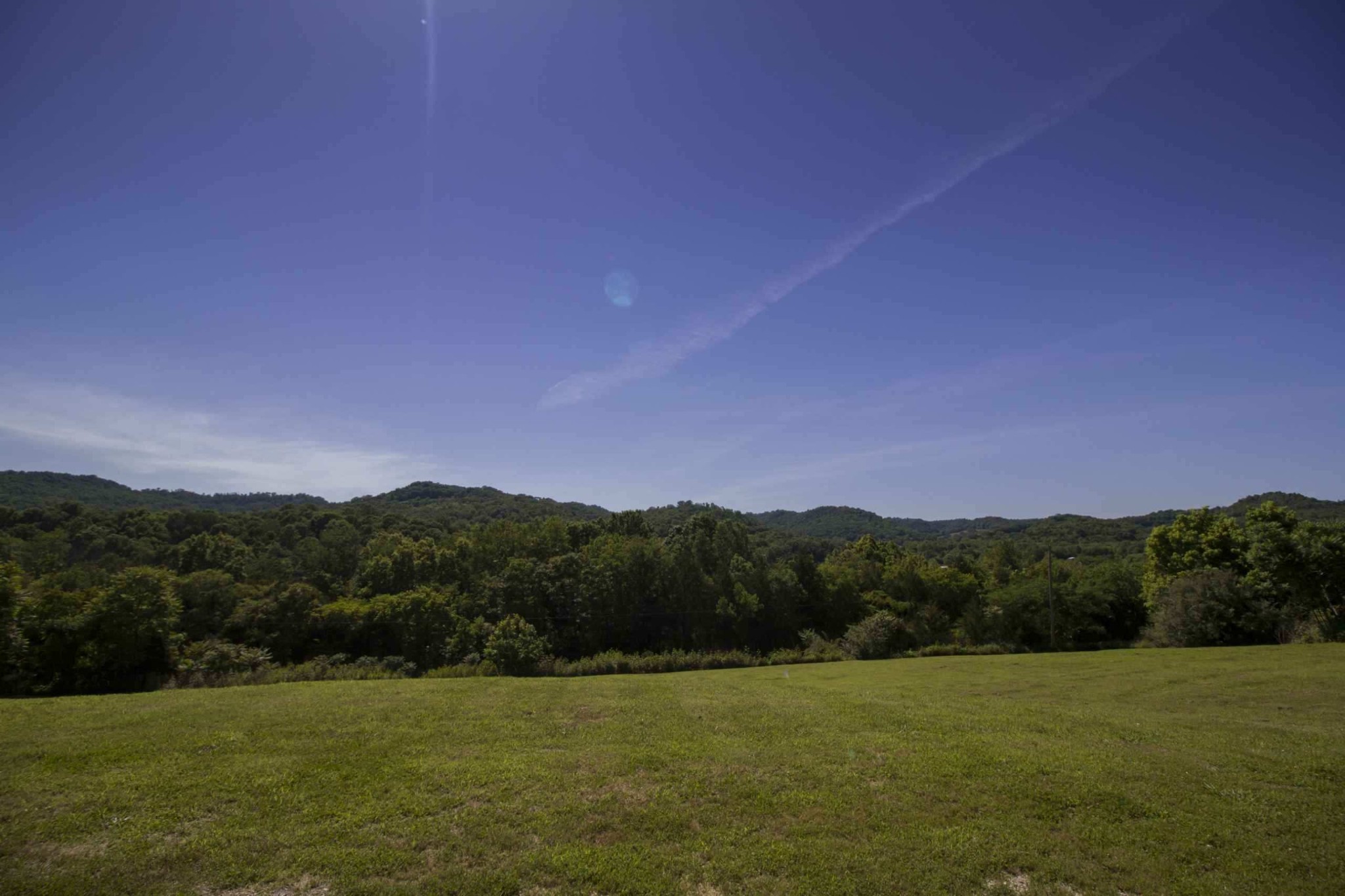 57 Lakeside Drive Carthage, TN 37030 - Photo 5 of 34 a view of a grassy field with mountains in the background