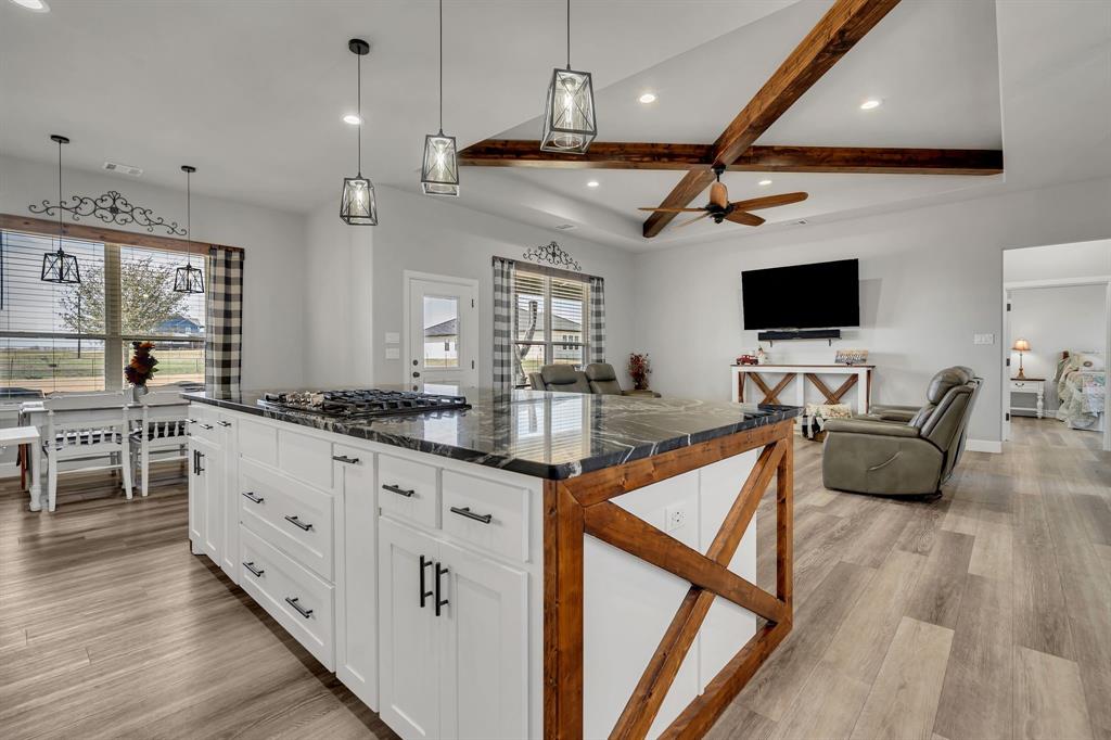 7739 Borth Road Sanger, TX 76266 - Photo 39 of 39 Kitchen with a kitchen island, beam ceiling, open floor plan, light wood-type flooring, and a ceiling fan