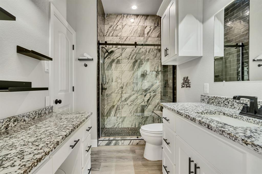 7739 Borth Road Sanger, TX 76266 - Photo 25 of 39 En suite bathroom with vanity and a marble finish shower