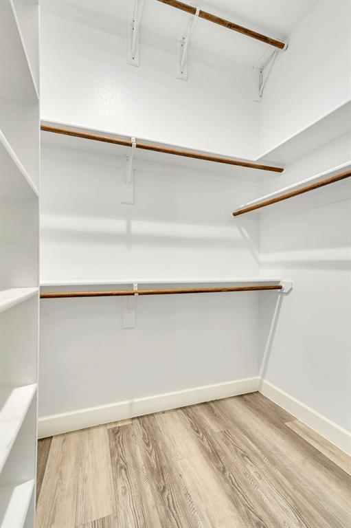 7739 Borth Road Sanger, TX 76266 - Photo 26 of 39 Guest Bedroom walk in closet with light wood-style floors