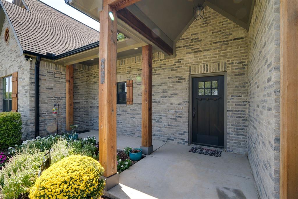 7739 Borth Road Sanger, TX 76266 - Photo 3 of 39 Entrance to property with brick siding and a porch