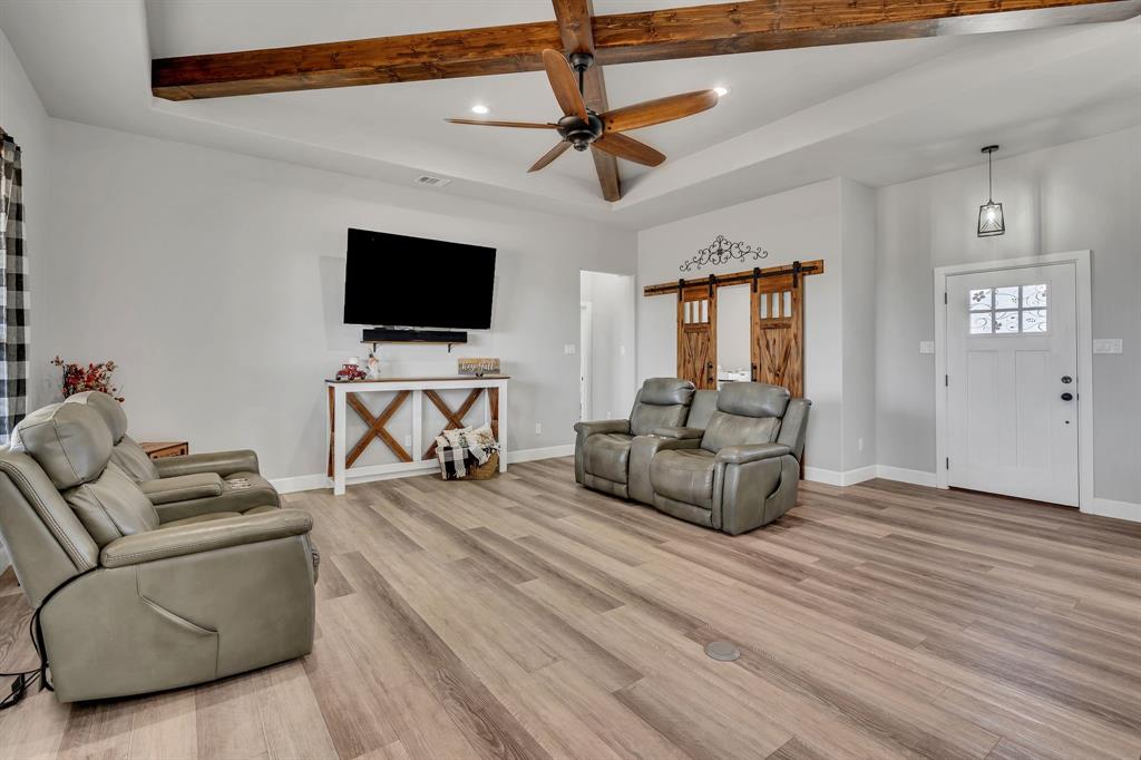 7739 Borth Road Sanger, TX 76266 - Photo 5 of 39 Living room featuring a barn door, light wood-style flooring, ceiling fan, and recessed lighting