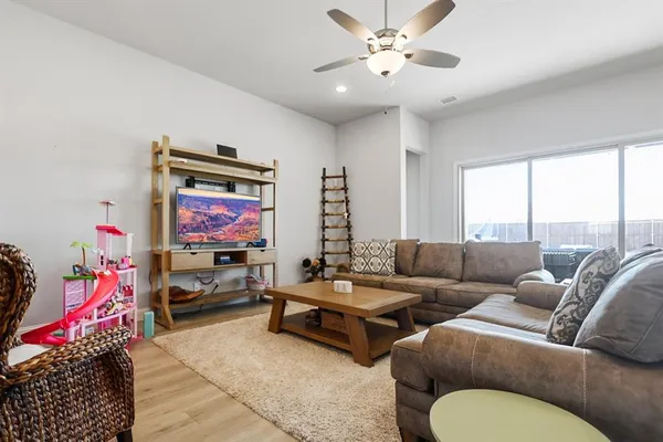 a living room with furniture a rug and a chandelier