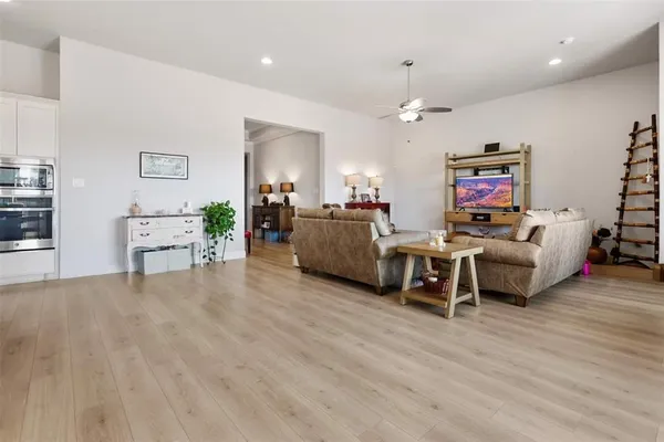 a living room with furniture and wooden floor
