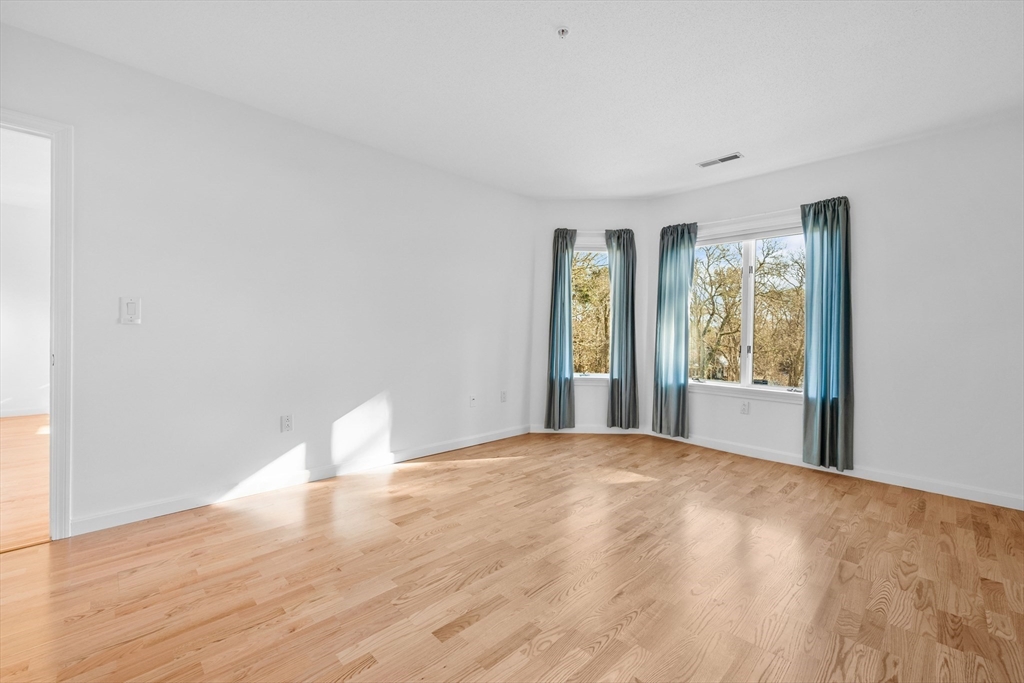 52 Kates Path, Unit 52 Yarmouth, MA 02675 - Photo 17 of 33 a view of a big room with windows and chandelier fan