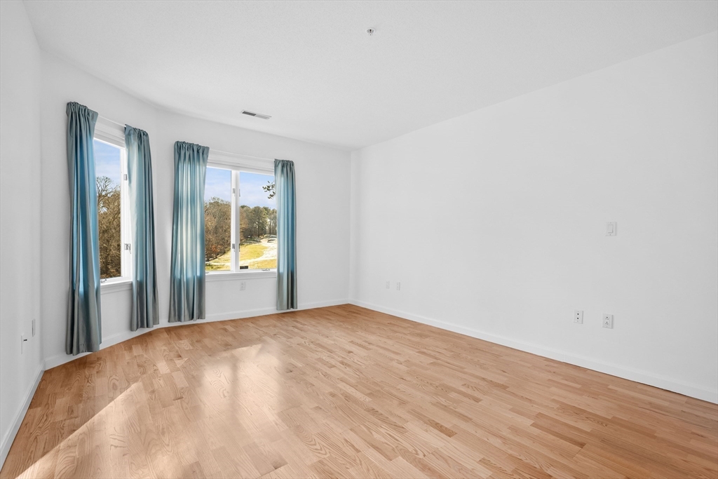52 Kates Path, Unit 52 Yarmouth, MA 02675 - Photo 18 of 33 a view of a big room with wooden floor and windows
