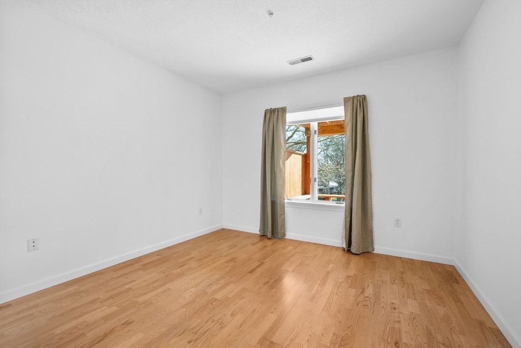 52 Kates Path, Unit 52 Yarmouth, MA 02675 - Photo 27 of 33 a view of empty room with wooden floor and fan
