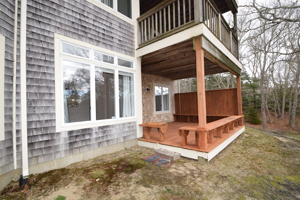 52 Kates Path, Unit 52 Yarmouth, MA 02675 - Photo 31 of 33 a view of a house with a large window and wooden fence