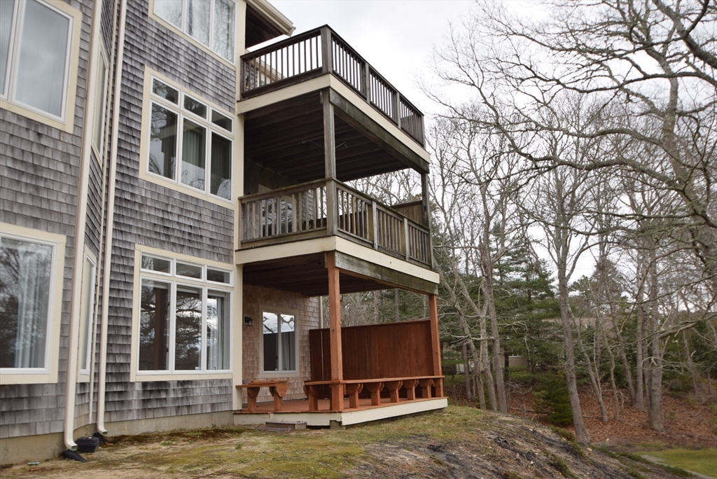 52 Kates Path, Unit 52 Yarmouth, MA 02675 - Photo 32 of 33 a view of a house with a small yard and large tree