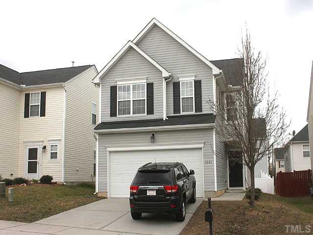 a view of a car parked in front of a house