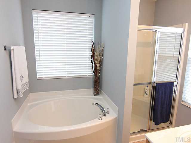 4461 Snowcrest Lane Raleigh, NC 27616 - Photo 11 of 25 a white bath tub sitting next to a window
