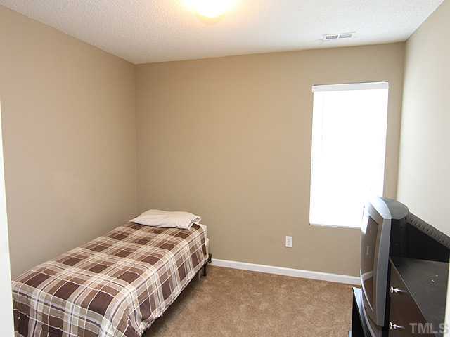 4461 Snowcrest Lane Raleigh, NC 27616 - Photo 13 of 25 a bedroom with a bed and a window