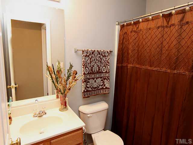 4461 Snowcrest Lane Raleigh, NC 27616 - Photo 14 of 25 a bathroom with a sink toilet and shower