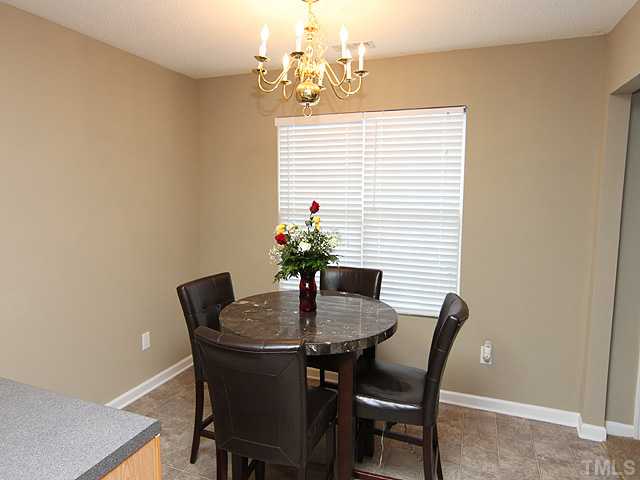 4461 Snowcrest Lane Raleigh, NC 27616 - Photo 4 of 25 a dining room with furniture and window