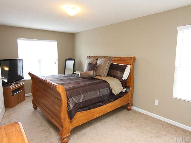 4461 Snowcrest Lane Raleigh, NC 27616 - Photo 8 of 25 a bedroom with a bed and a flat screen tv