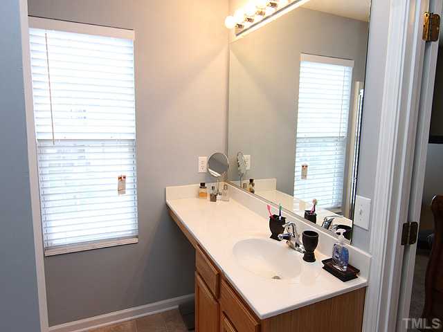 4461 Snowcrest Lane Raleigh, NC 27616 - Photo 10 of 25 a bathroom with a sink and a window