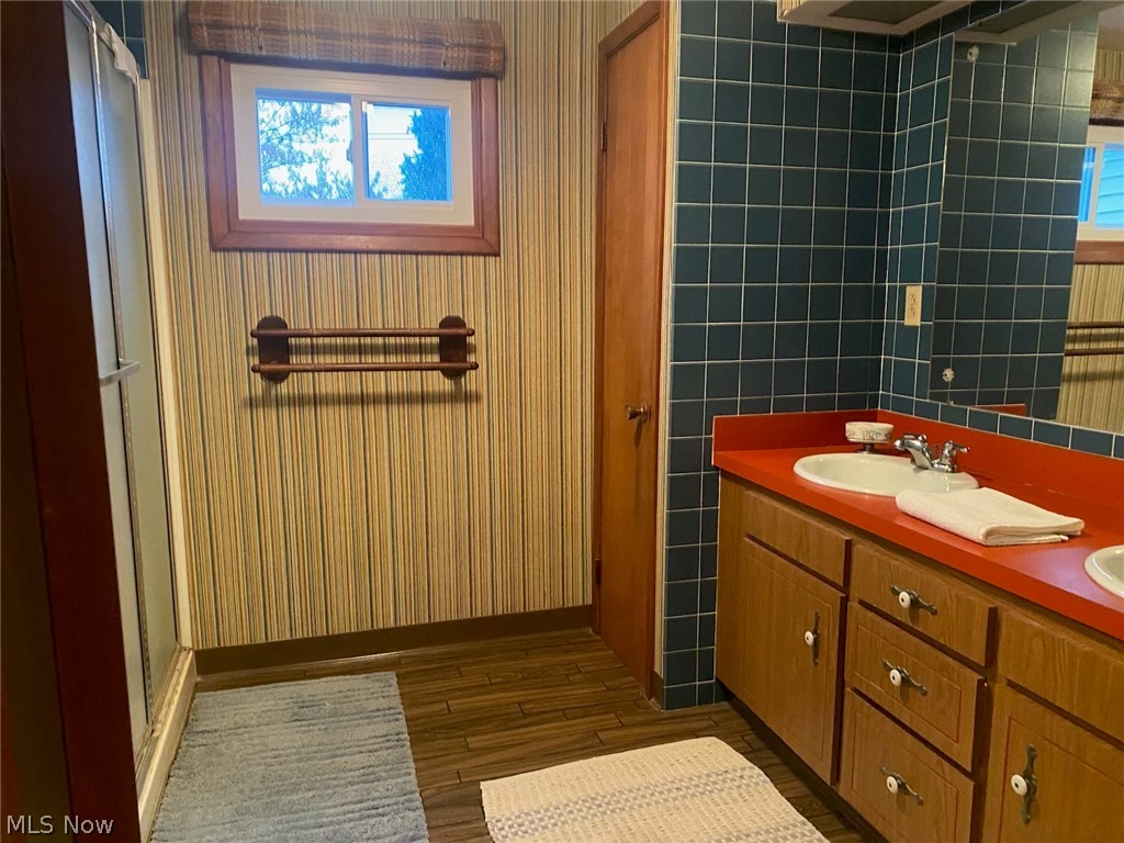 30300 Oakdale Road Willowick, OH 44095 - Photo 8 of 10 First floor bathroom with a walk in shower,has hardwood flooring, a linen closet and double sinks.