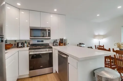 a kitchen with a stove a sink and a refrigerator