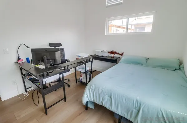 a bed room with a bed and a chair
