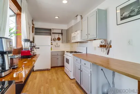 a kitchen with cabinets wooden floor and a sink