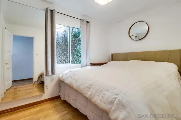 a bedroom with a bed and window
