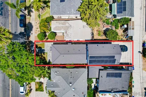 an aerial view of a houses with a yard