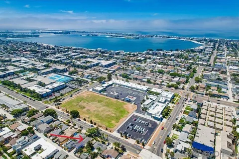 an aerial view of a house with a yard and lake view