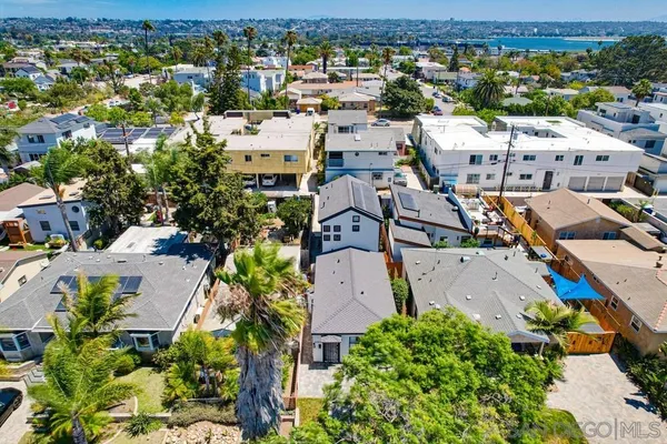 an aerial view of residential houses with outdoor space
