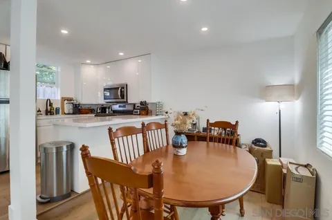 a dining room with furniture and a chandelier