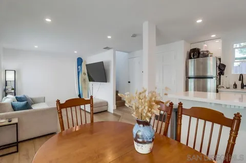 a living room with furniture fireplace and dining table